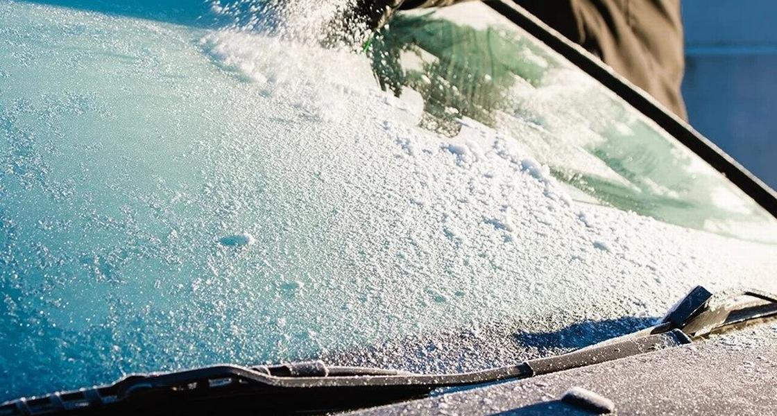 windshield defroster A person defrosts a windshield
