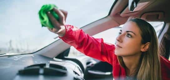 A person cleans the windshield