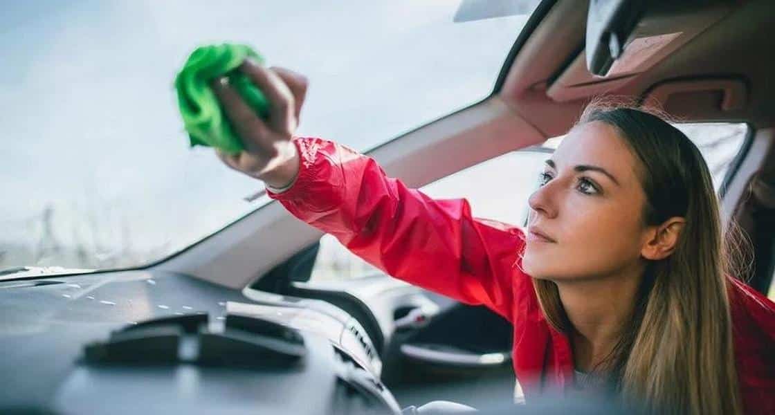 A person cleans the windshield